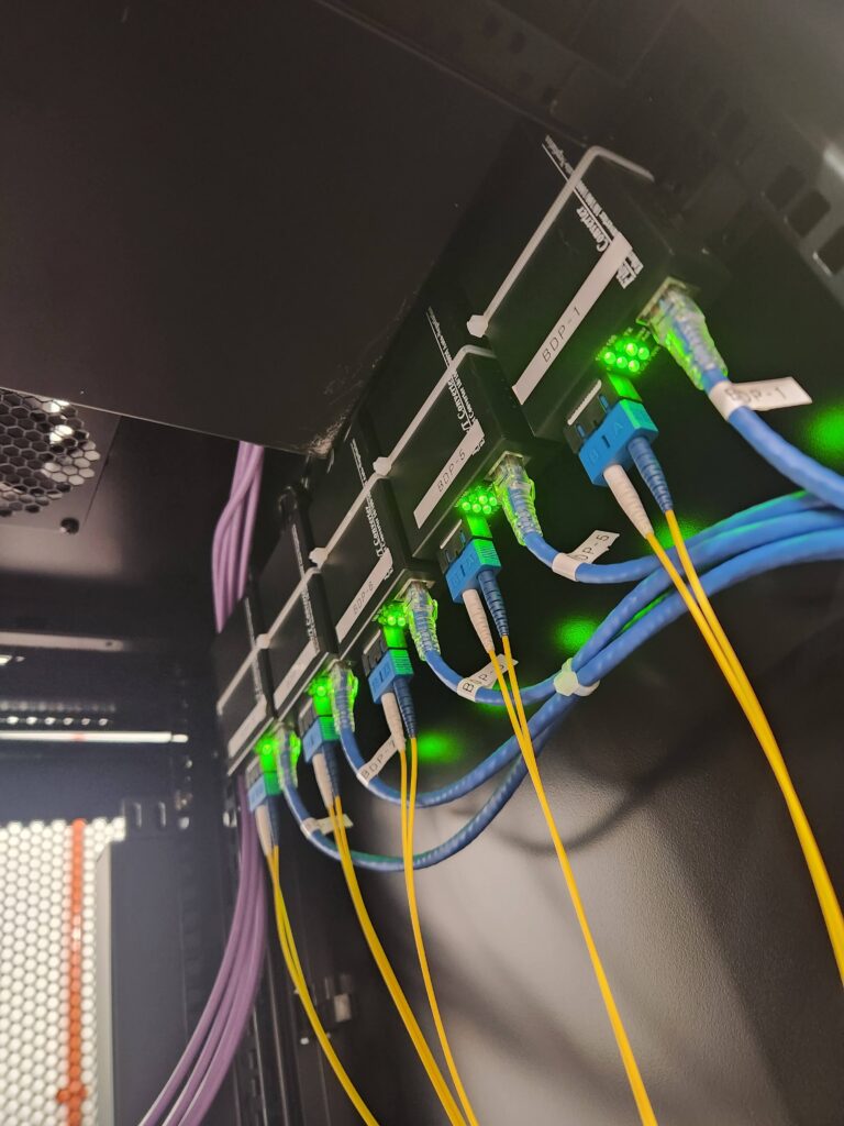 Neatly routed fiber optic splicing tray and cable management works inside industrial deployment environment