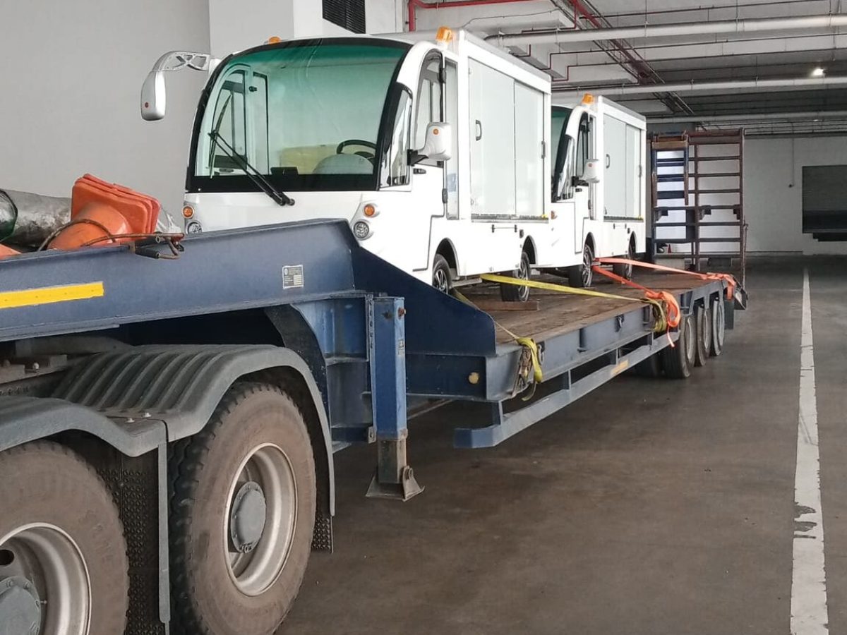 Electric cargo buggies transported for delivery and commissioning at a customer site in Singapore.